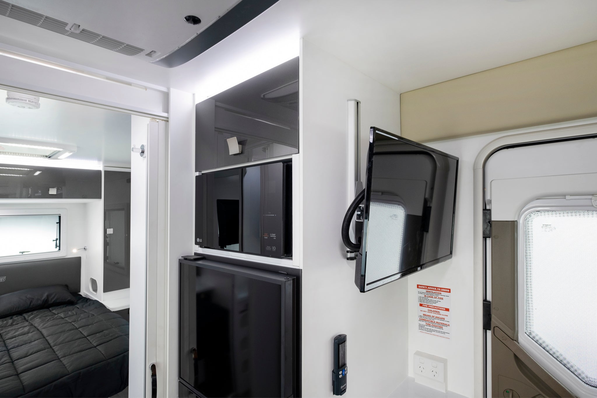 Iluka interior view of bed, tv, microwave and fridge