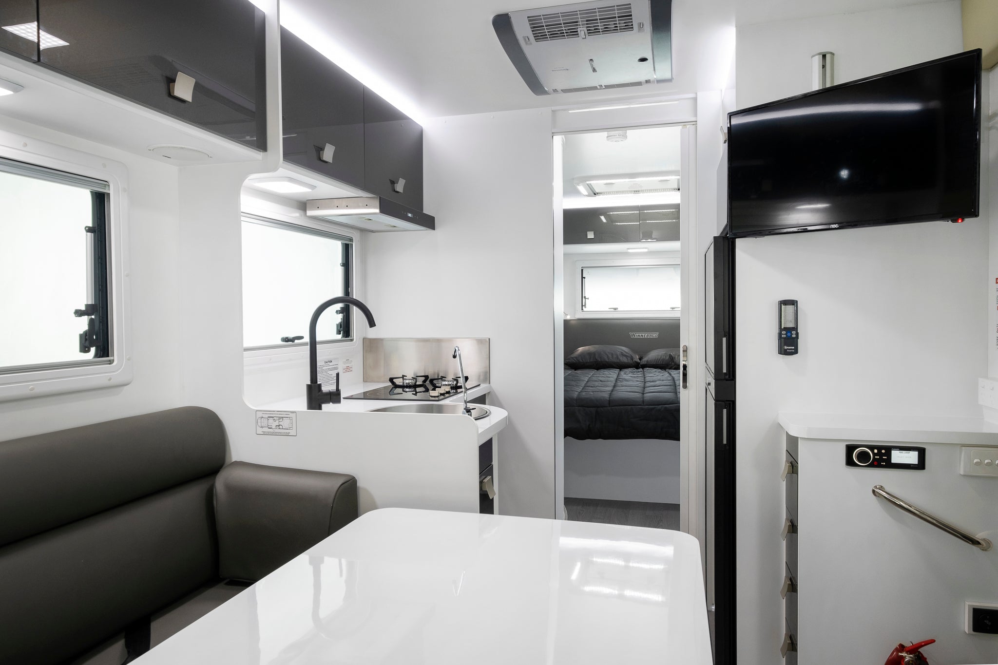 Iluka interior view of dinette and kitchen with door to bed