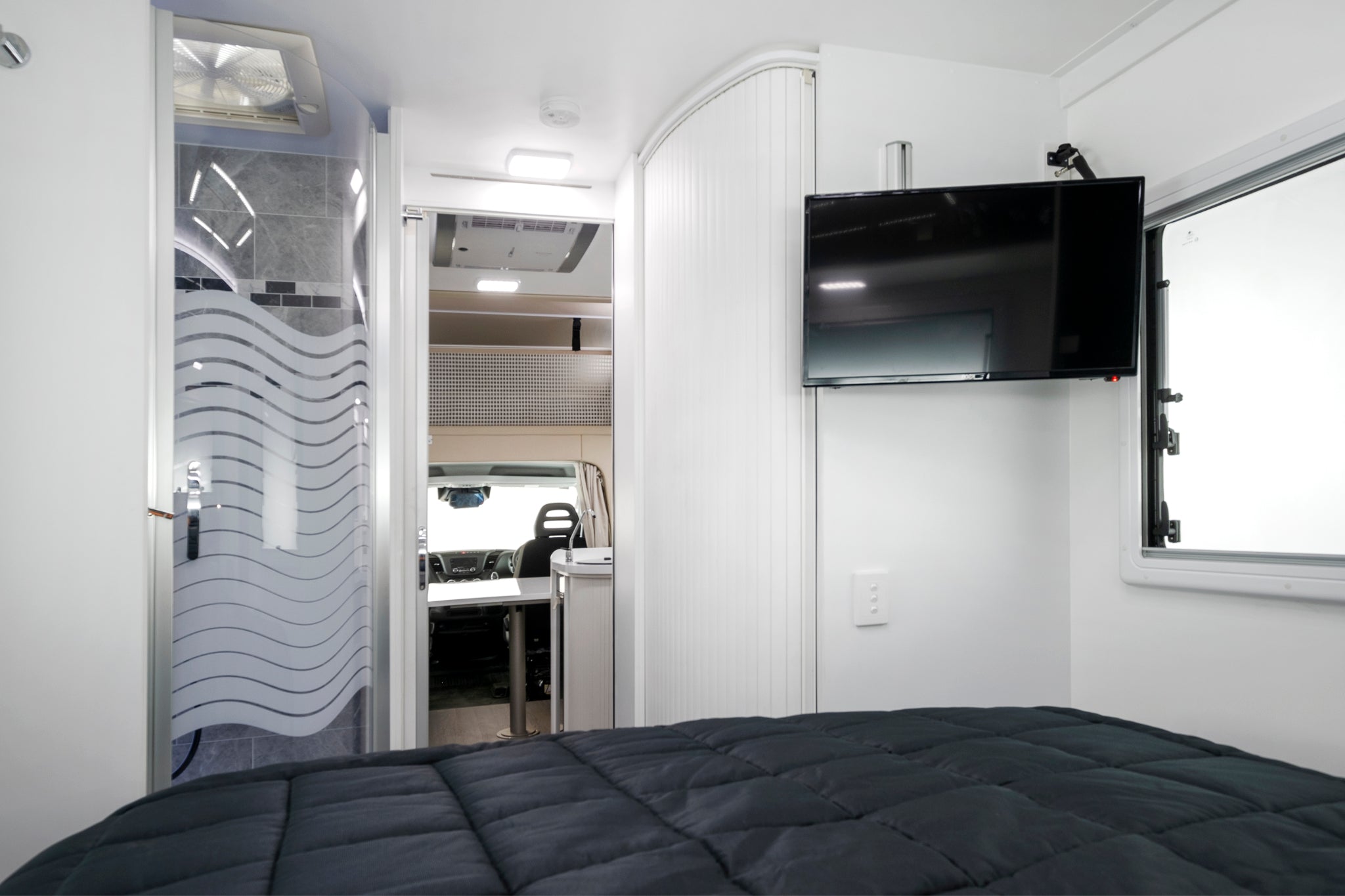 Winnebago Iluka bed with shower and television
